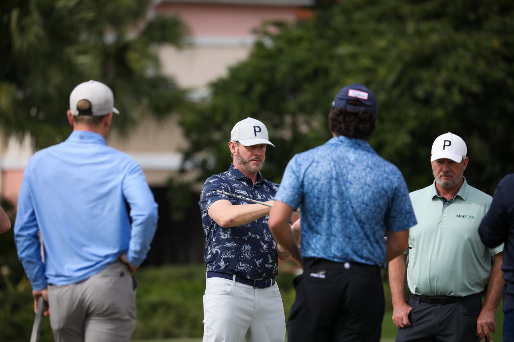 An AimPoint coach demonstrating a green read to students during a Performance School